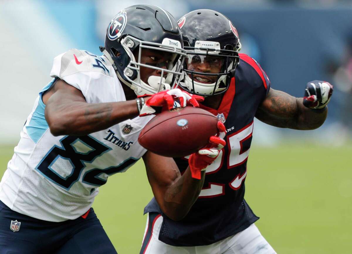 Tennessee Titans wide receiver Corey Davis (84) makes a reception against Houston Texans defensive back Kareem Jackson (25) during the second quarter of an NFL football game at Nissan Stadium on Sunday, Sept. 16, 2018, in Nashville.