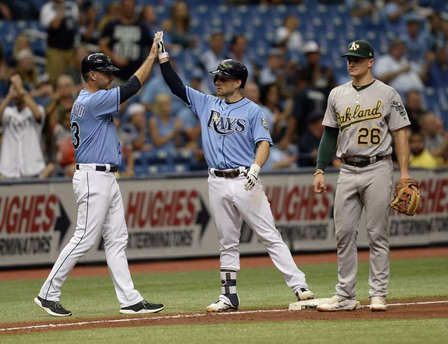 tampa bay rays third base coach matt quatraro (33) congratulates