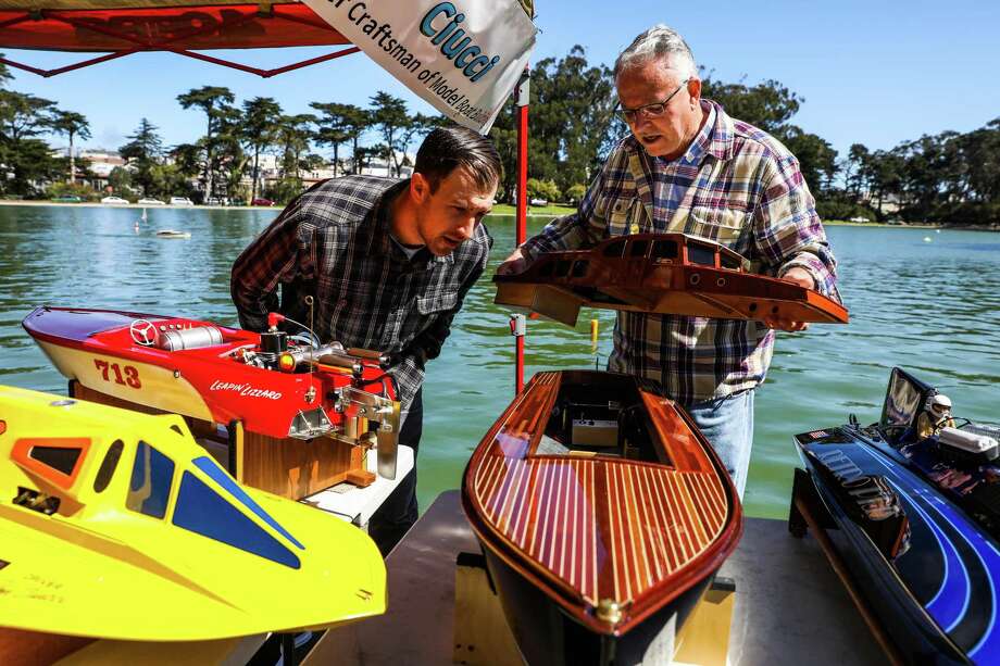 Matthew Ciucci chats with artisan Jim Renfrew (right) as they discuss the boats he made at Spreckels Lake. Photo: Gabrielle Lurie / The Chronicle / ONLINE_YES