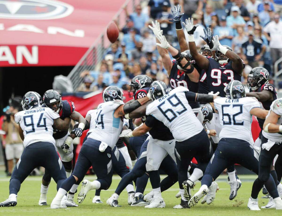 Houston Texans defenders leap in vain for Tennessee Titans kicker Ryan Succop's 42-yard field goal during the fourth quarter of an NFL football game at Nissan Stadium on Sunday, Sept. 16, 2018, in Nashville.