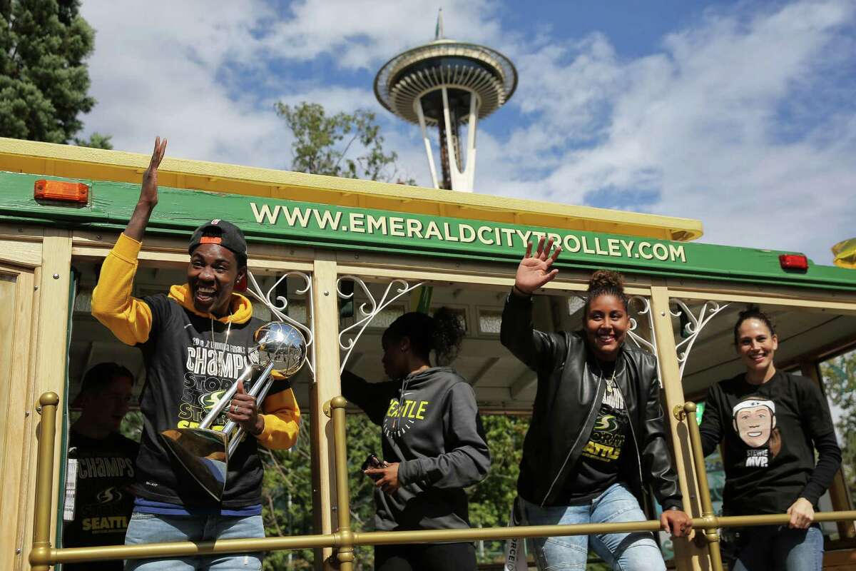 Seattle Storm players (from left) Natasha Howard. Jordin Canada, Kaleena Mosqueda-Lewis and Sue Bird wave at fans from the trolley during a parade to celebrate the Storm winning the 2018 WNBA basketball championship, Sunday, Sept. 16, 2018, in Seattle.