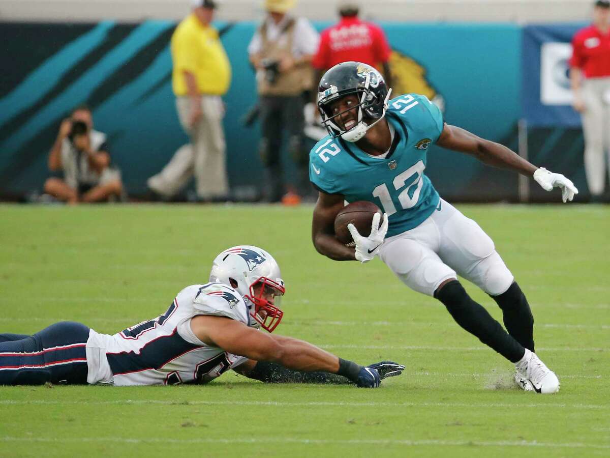 Jacksonville Jaguars wide receiver Dede Westbrook (12) runs for a touchdown past New England Patriots linebacker Kyle Van Noy, left, on a 61-yard pass play against the New England Patriots during the second half of an NFL football game, Sunday, Sept. 16, 2018, in Jacksonville, Fla. (AP Photo/Stephen B. Morton)