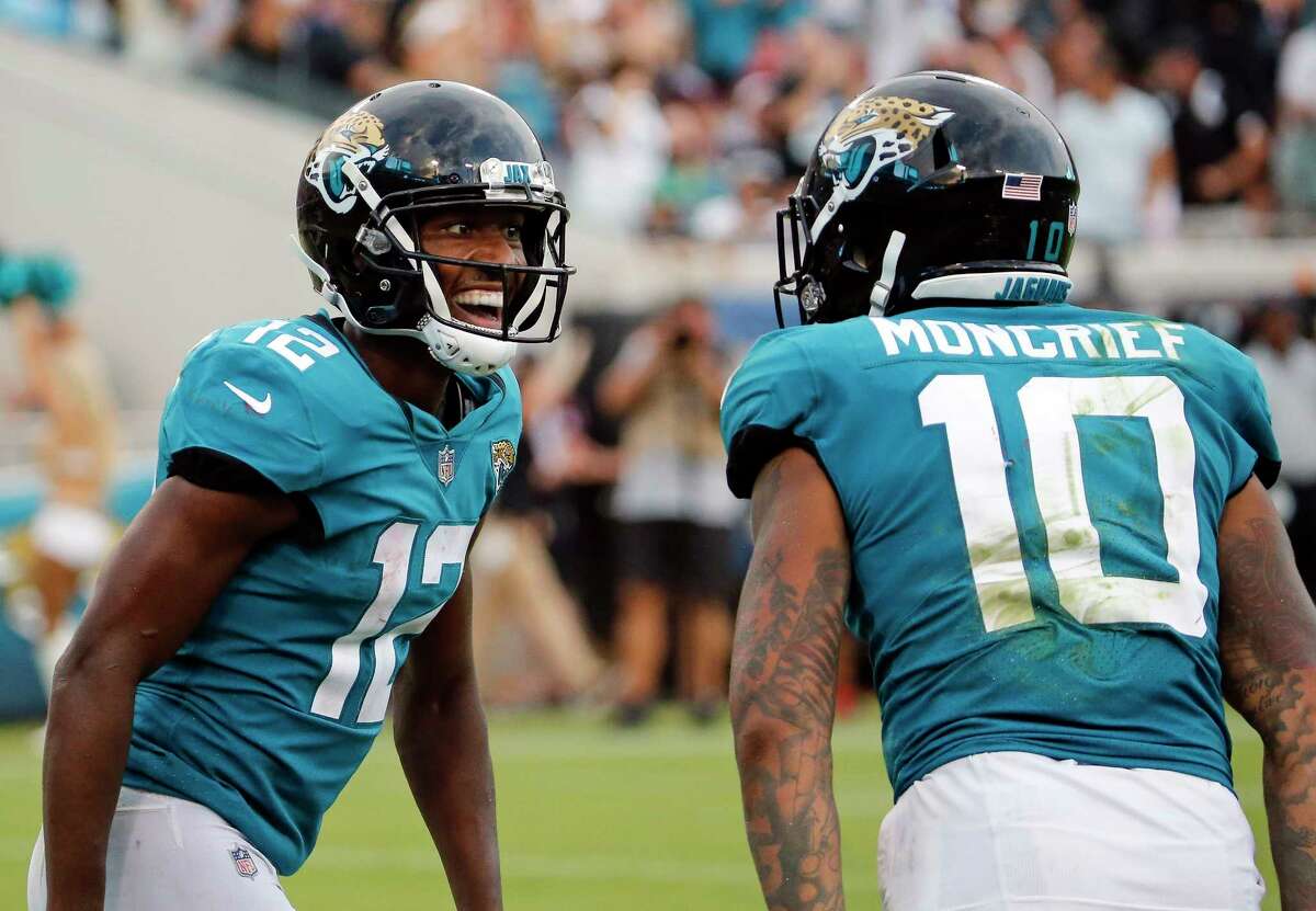 Jacksonville Jaguars wide receiver Dede Westbrook (12) celebrates his 61-yard touchdown against the New England Patriots with teammate wide receiver Donte Moncrief (10) during the second half of an NFL football game, Sunday, Sept. 16, 2018, in Jacksonville, Fla. (AP Photo/Stephen B. Morton)