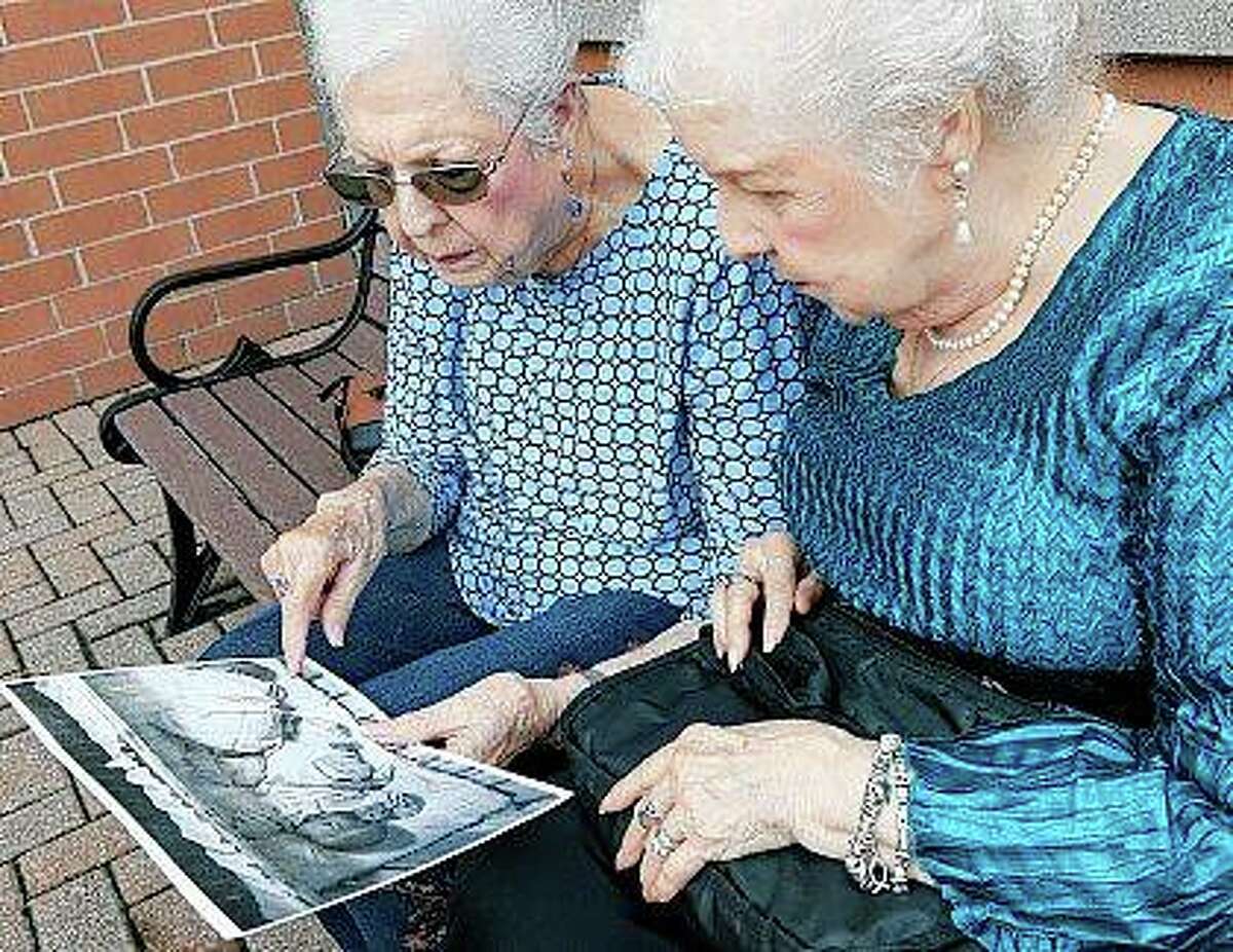 Jean Harrison of Algonquin (left) and Jane Umbarger of McHenry, known as the “incubator twins,” look at a photo of their infancy as they talk about their experiences. The twin sisters, both 84, were among hundreds of premature infants placed in incubators at the Century of Progress expo in Chicago in 1933 and 1934. They also had a double wedding in 1953, which drew national attention.