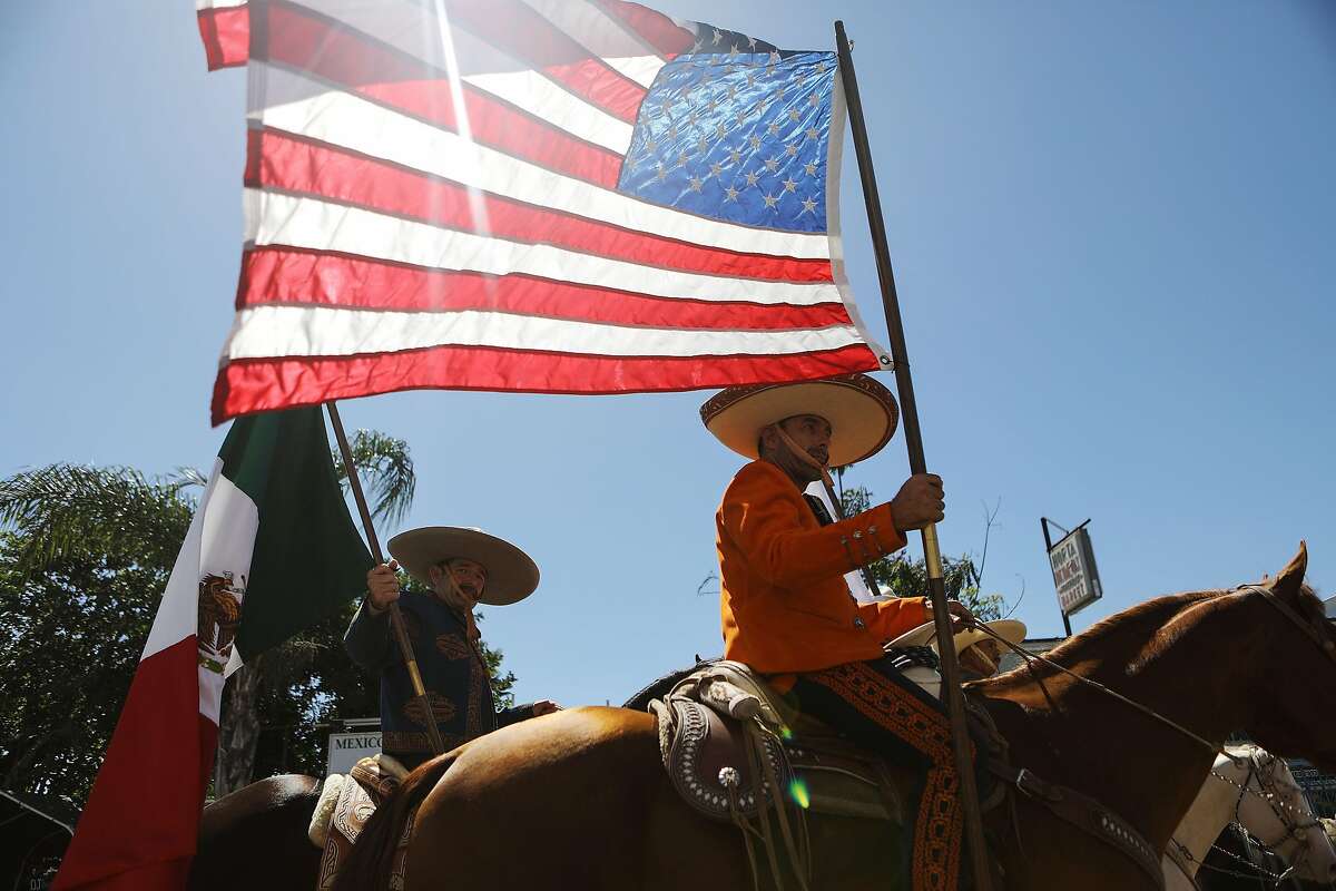 LOS ANGELES, CA - SEPTEMBER 16: Revelers parade on horseback with American and Mexican flags during the 72nd annual East LA Mexican Independence Day Parade on September 16, 2018 in Los Angeles, California. 11.6 million immigrants from Mexico lived in the U.S. in 2016, making Mexico the top country of origin of U.S. immigrants, according to the Pew Research Center. (Photo by Mario Tama/Getty Images)