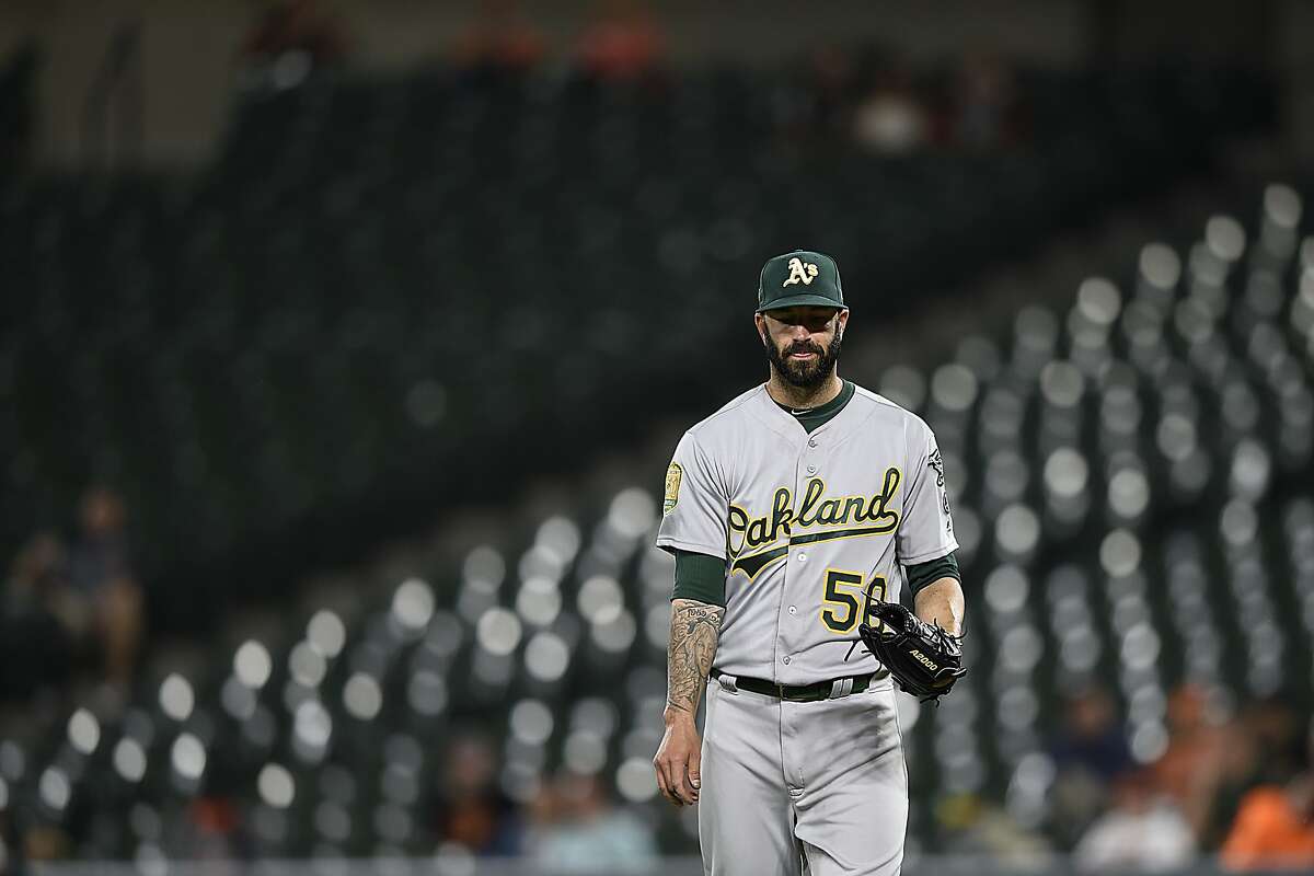 Oakland Athletics pitcher Mike Fiers pauses between pitches against the Baltimore Orioles in the third inning of a baseball game, Tuesday, Sept. 11, 2018, in Baltimore. The Athletics won 3-2.(AP Photo/Gail Burton)