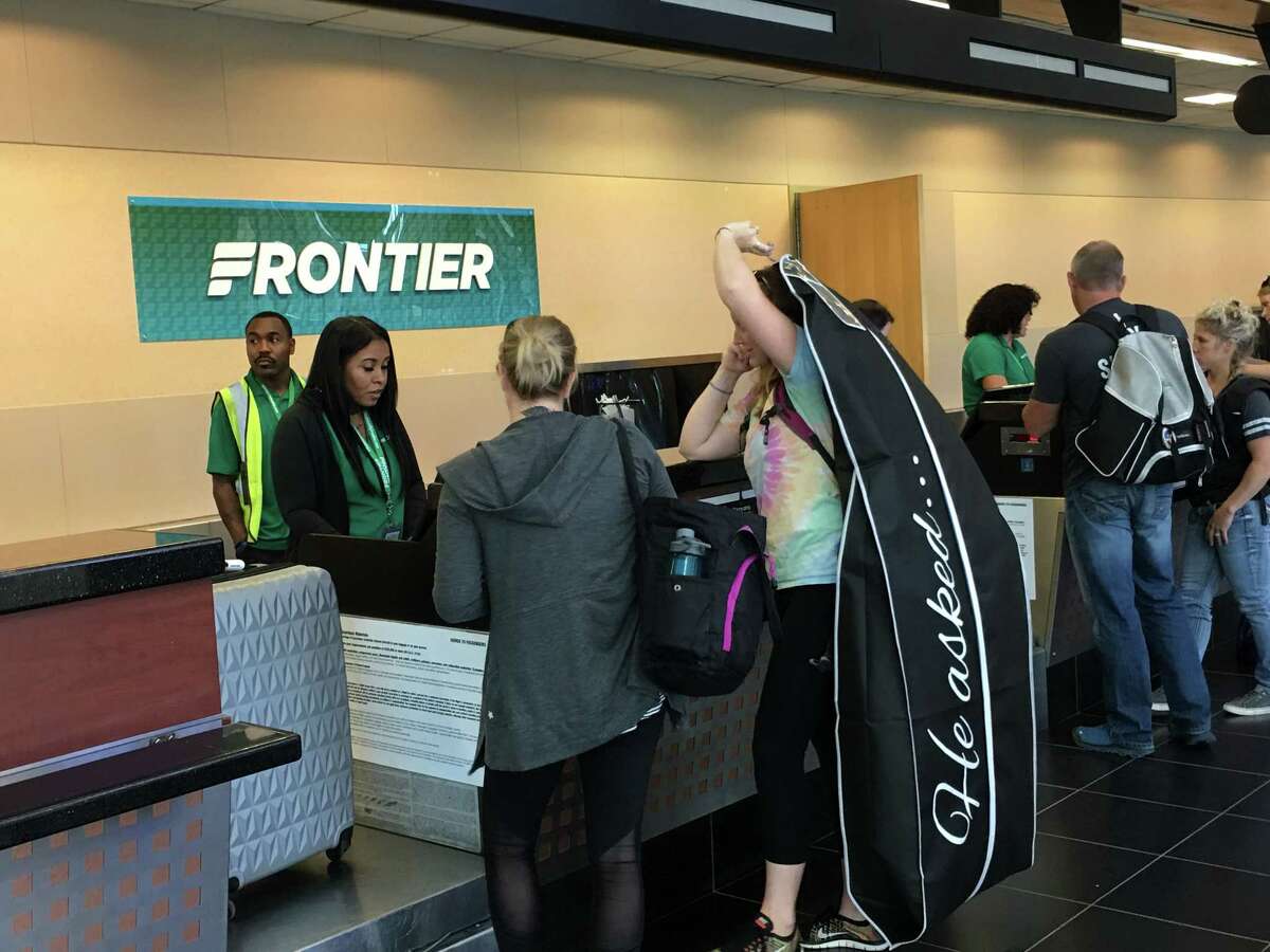 Passengers check in Monday morning for Frontier Airlines' first flight from Albany to Denver. The ultra-low fare carrier will offer flights to Denver on Mondays and Fridays.