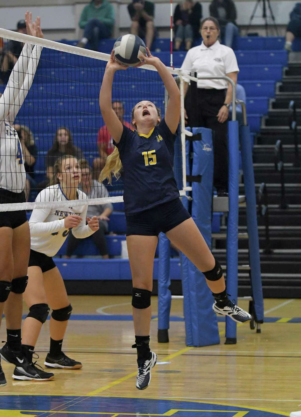 Woodstock Academy?’s Sammie Orlowski sets the ball during the Woodstock Academy at Newtown High School girls volleyball game, Sept. 17, 2018.