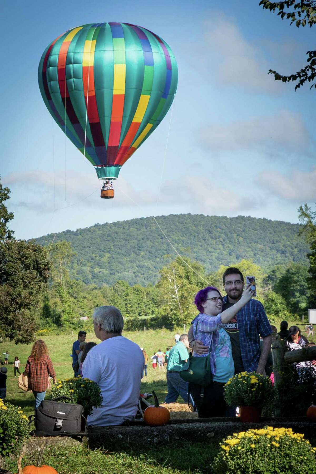 Elizabeth Edwards and Javier Martinez of New Milford pose for a selfie with the hot-air balloon as the background during the Weantinoge Heritage Land Trust fall celebration on Saturday, September 15, 2018, at Smyrski Farm in New Milford, CT. Liberty Balloon Company out of Groveland, NY, gave tethered hot-air balloon rides starting at 8am.