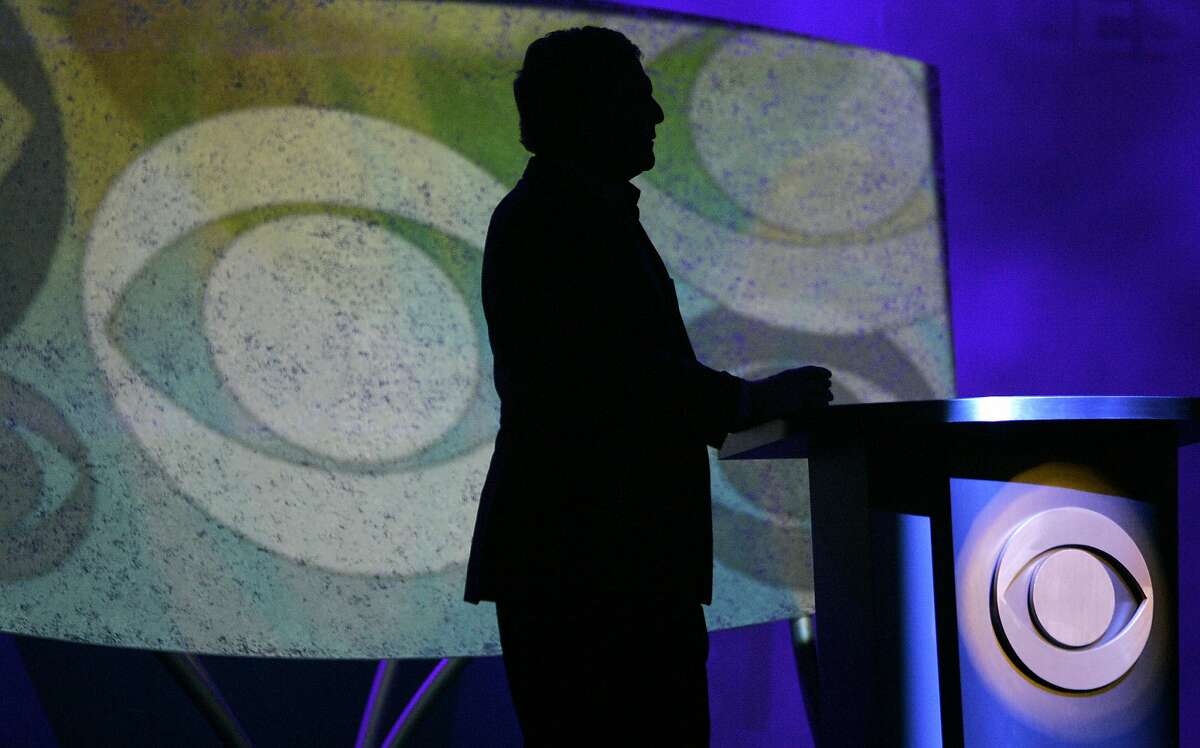 FILE- In this Jan. 9, 2007, file photo Leslie Moonves, president and CEO of CBS Corp., is silhouetted while watching a video presentation during his keynote speech at the Consumer Electronics Show in Las Vegas. Moonves, who was ousted over the weekend as head of CBS Corp. amid a continuing investigation into allegations of sexual misconduct, began working as CBS entertainment division president in 1995 and built the network into the corporation's profitable crown jewel. (AP Photo/Jae C. Hong, File)
