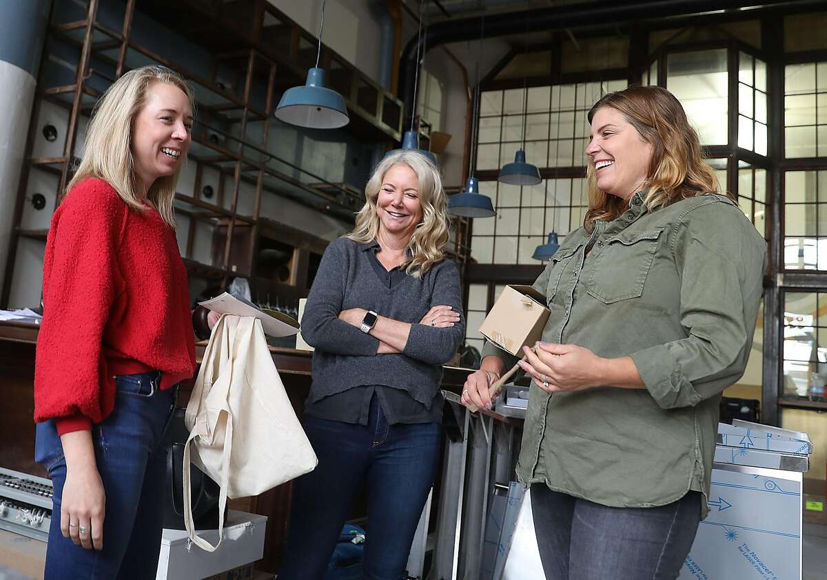 Designer Hannah Collins (left) talks with co-founder of New Belgium brewing company and executive chair of Magnolia Kim Jordan (middle and project manager Hannah Walbridge (right)) seen at the bar of the new Magnolia bar and brewery in the Dogpatch on Monday, Sept. 17, 2018, in San Francisco, Calif.