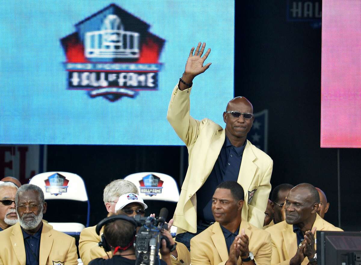 FILE - In this Aug. 2, 2014, file photo, enshrinee Eric Dickerson is introduced during the Pro Football Hall of Fame enshrinement ceremony, in Canton, Ohio. A group of Pro Football Hall of Famers is demanding health insurance coverage and a share of NFL revenues or else those former players will boycott the induction ceremonies. In a letter sent to NFL Commissioner Roger Goodell, NFLPA Executive Director DeMaurice Smith and Hall of Fame President David Baker � and obtained by The Associated Press � 21 Hall of Fame members cited themselves as "integral to the creation of the modern NFL, which in 2017 generated $14 billion in revenue." Among the signees were Eric Dickerson. (AP Photo/David Richard, File)
