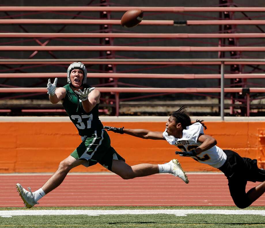 De La Salle's Grant Daley (37) goes for a catch pursued by Antioch's Ke'Sean Patton (32) during a 7-on-7, no pads or linemen tournament featuring 16 local high school teams at Pittsburg High School in Pittsburg, Calif., on Saturday, June 30, 2018. The tournament focused on technique and athleticism without the typical physicality of using linemen in order to prevent injury. Photo: Carlos Avila Gonzalez / The Chronicle