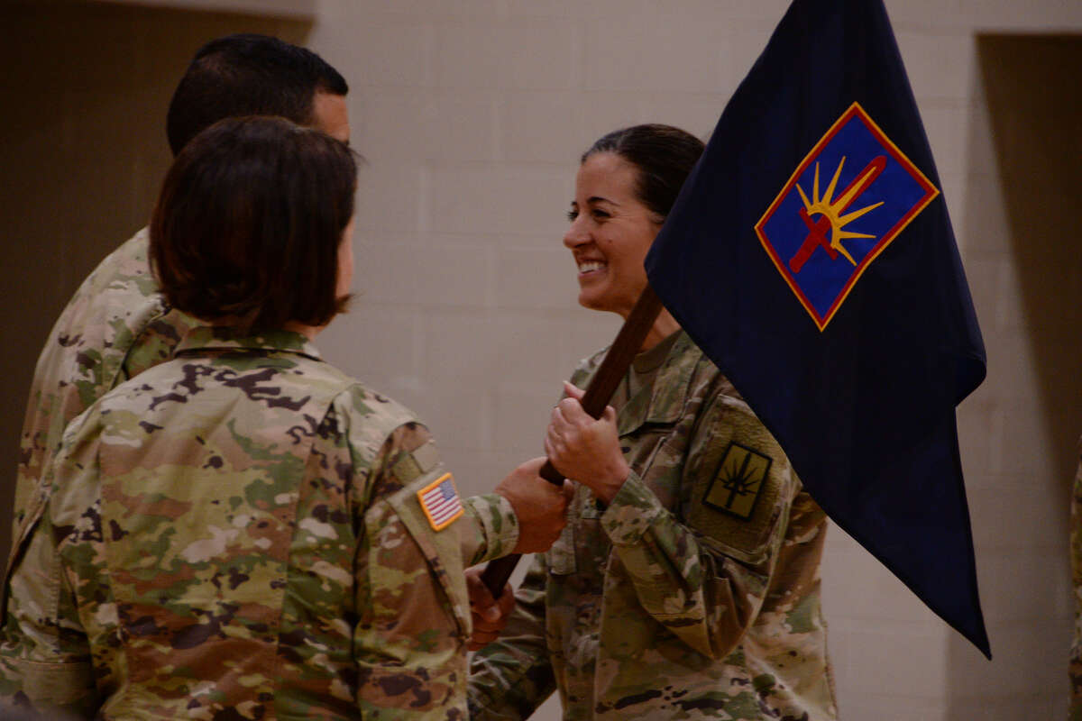 New York Army National Guard Maj. Amy Crounse receives guidon of the Joint Force Headquarters and Headquarters Detachment from Chief of Staff Col. John Andonie during a change of command in Latham.
