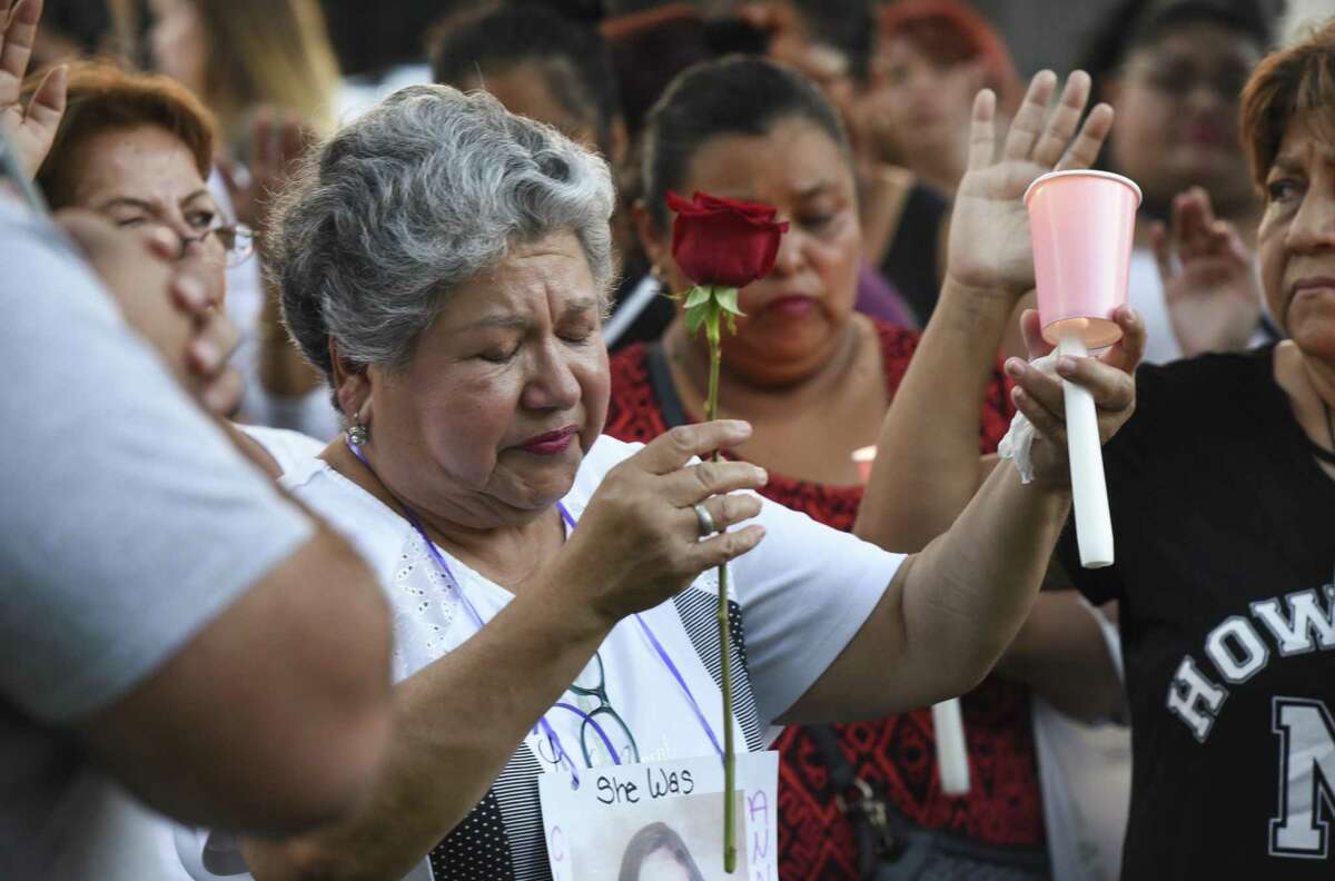 Family and friends of the four alleged victims of Juan David Ortiz gather at San Agustin plaza for a candlelight vigil on Tuesday, Sept. 18, 2018.
