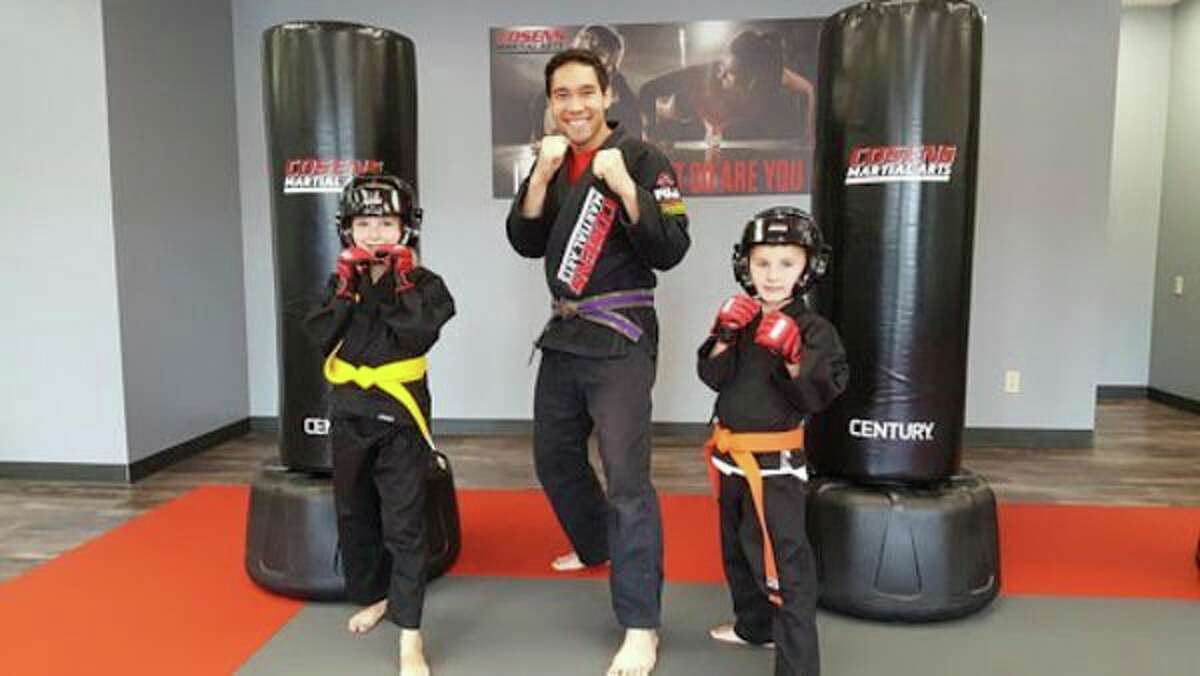 Coach Steven Decatur with two of his martial art students. (Photo provided)