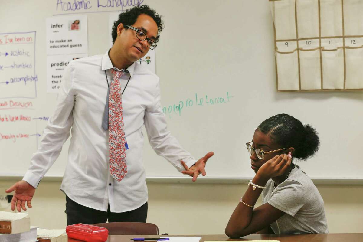 Cesar Cano, a teacher at Pasadena Memorial High School and is also a finalist on FOX's "MasterChef, gives positive reinforcement to Mea Randall Monday, Sept. 17, 2018, in Houston.