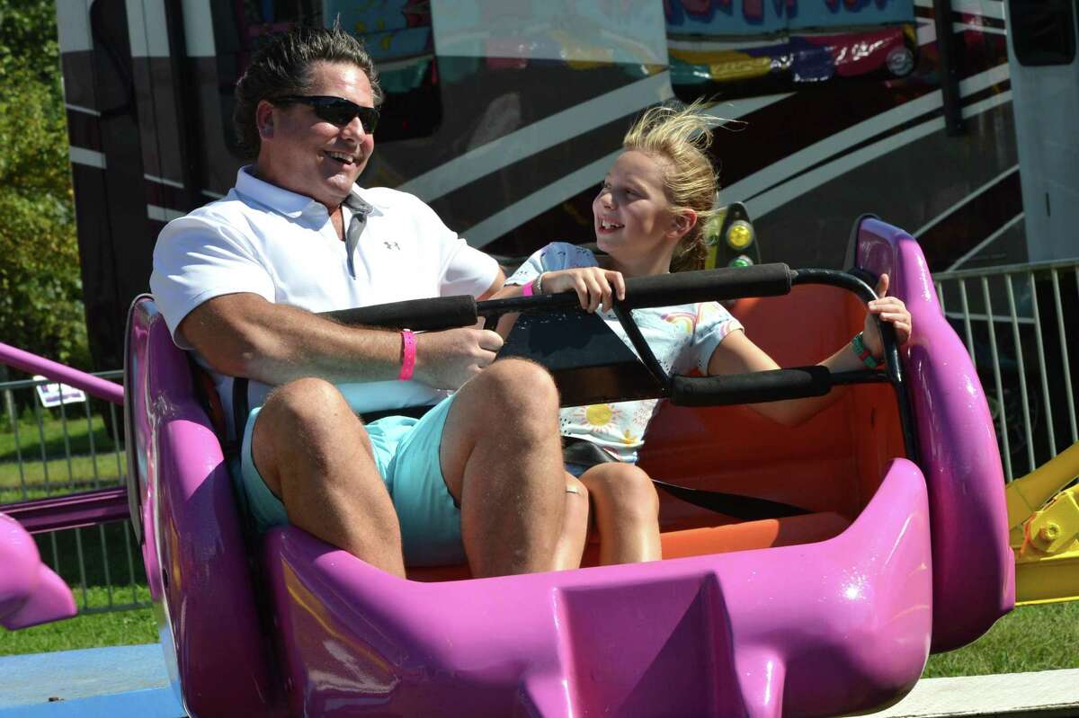 Rob Merkle and daughter Jackie get spun on the scrambler ride during the Wilton Rotary Club annual family carnival on Sunday September 16, 2018 in Wilton Conn. The event is a fundraiser that benefits the Wilton Rotary Club's community improvement projects both locally and internationally.