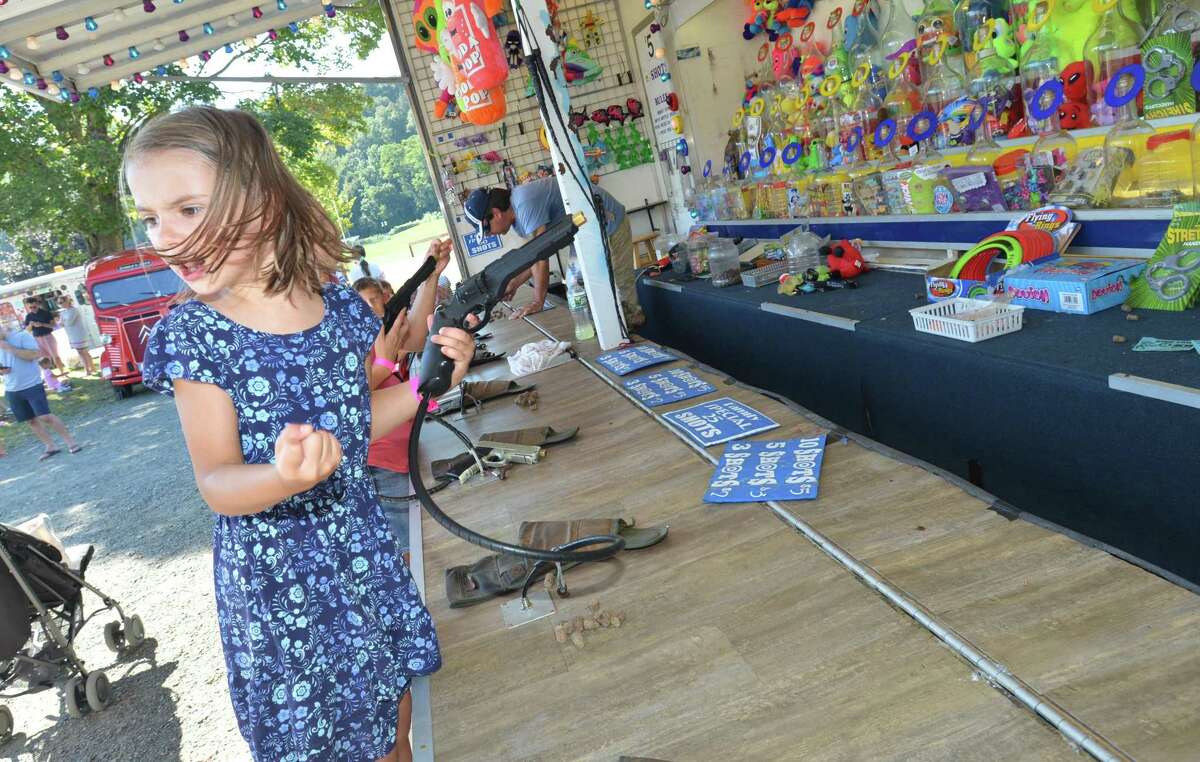 Abbie Anderson reacts to a bullseye while playing ringshot with her mom Ashlee during the Wilton Rotary Club annual family carnival on Sunday September 16, 2018 in Wilton Conn. The event is a fundraiser that benefits the Wilton Rotary Club's community improvement projects both locally and internationally.