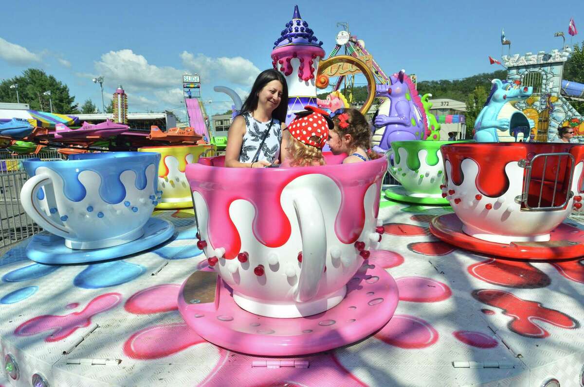 Laurie Miller takes a ride on the teacups with her daughter Morgan and her friend Lucy Nieman during the Wilton Rotary Club annual family carnival on Sunday September 16, 2018 in Wilton Conn. The event is a fundraiser that benefits the Wilton Rotary Club's community improvement projects both locally and internationally.