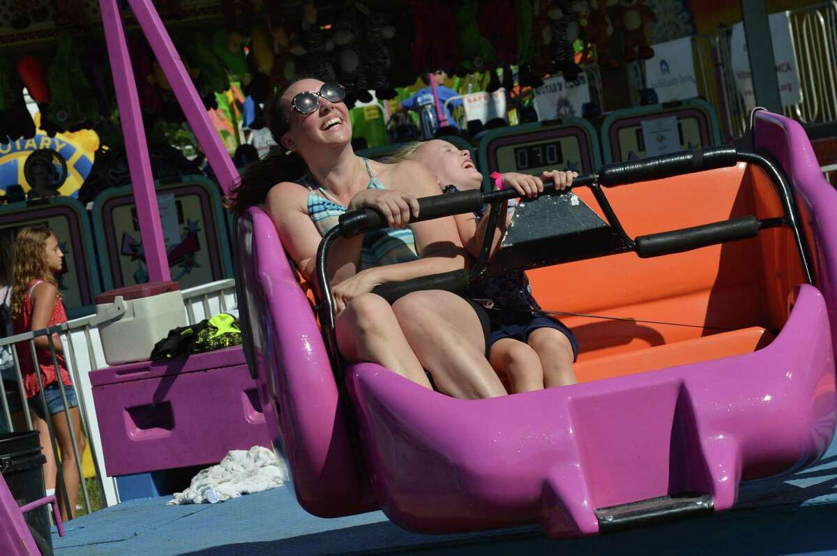 Wilton's Deb Runestad and daughter Gwendolyn take a spin on the scrambler ride during the annual Wilton Rotary Carnival on Sunday September 16, 2018 in Wilton Conn. The event featured rides, games, food and more and is a fundraiser that benefits the Wilton Rotary Club's community improvement projects both locally and internationally.