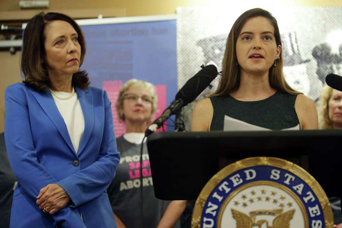 Sexual assault survivor Caitlin Flynn speaks alongside U.S. Senators Patty Murray and Maria Cantwell, left, who asked for a full FBI investigation of charges by Dr. Christine Blasey Ford who has accused Trump Supreme Court nominee Brett Kavanaugh of attempted rape, Wednesday, Sept. 19, 2018 at Planned Parenthood. Both Senators demand an FBI investigation into Ford's allegations.