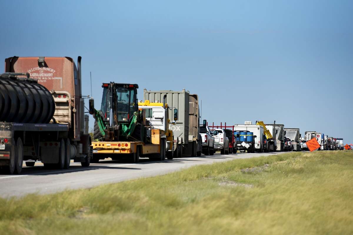 Trucks sit in traffic on Highway 302 near Kermit, Texas, U.S., on Friday, Aug. 24, 2018. Communities across the country are seeking funding for infrastructure needs.The good news for communities in the Permian Basin, and rural communities in general, is that funds may be easier to come by under the Trump administration.