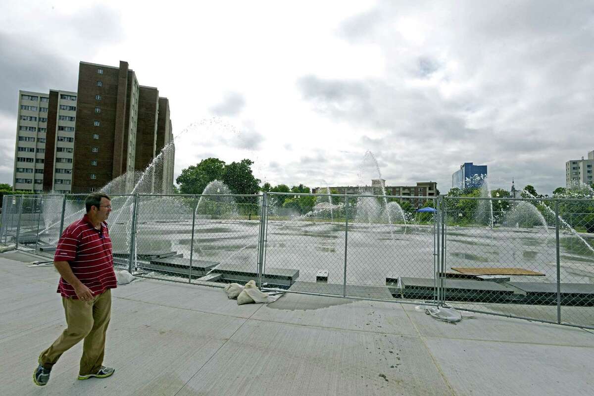 Scott Johnston, Co-Owner of Delta Fountians, Jacksonville, Florida tests one of six zones of the new fountain at Mill River Park. The fountain, which will also serve as an ice rink in the winter, is schedule to open next week. Johnston's company also help design the fountains at the World Trade Center memorial.