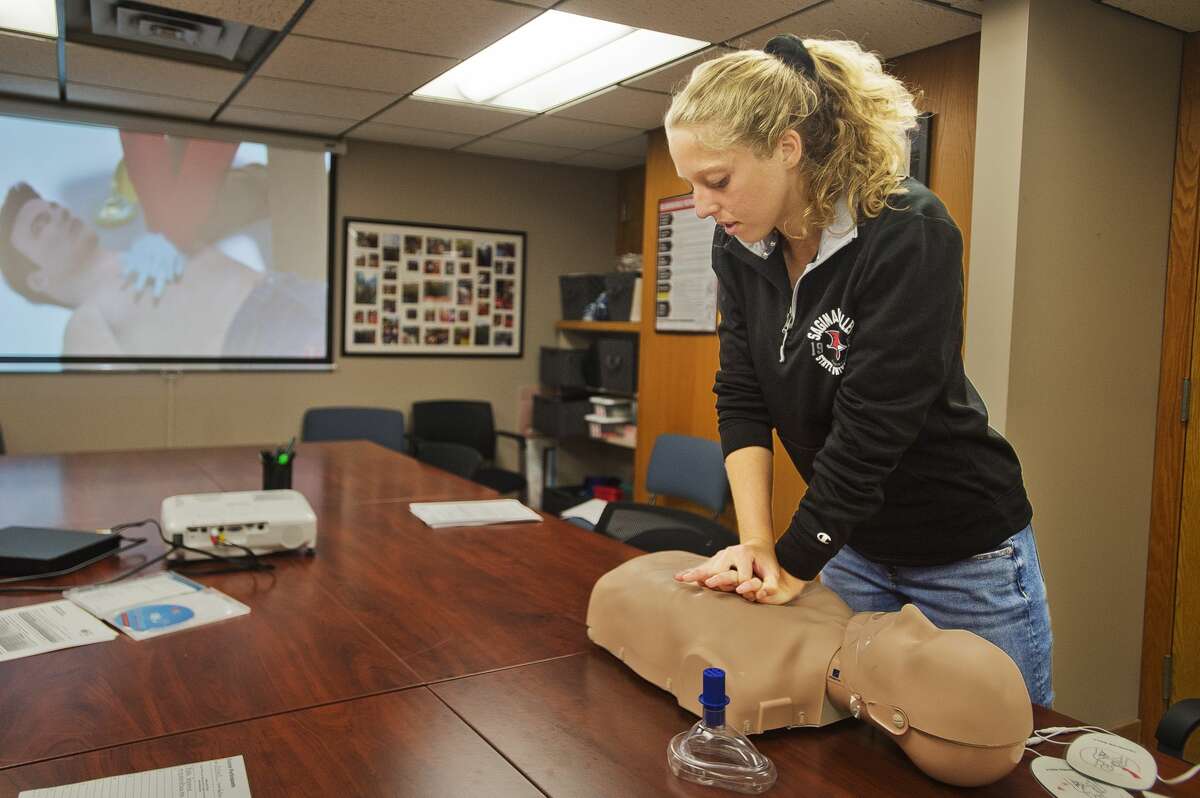 Saginaw Valley State University student Rylea Grassmid, 19, practices giving chest compressions during a CPR training session on Wednesday, Sept. 19, 2018 at Independent Community Living in downtown Midland. (Katy Kildee/kkildee@mdn.net)