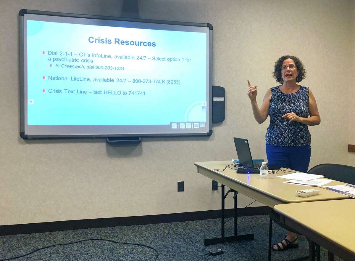 Margaret Watt, executive director of the Southwest Regional Mental Health Board, teaches suicide prevention training to a group of residents at Town Hall in Greenwich, Conn.