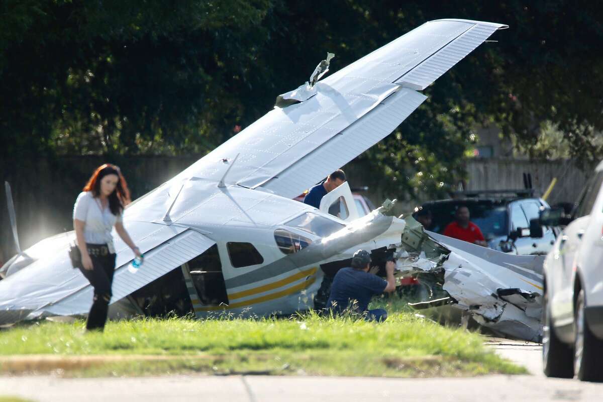 Investigators look at a small plane that crashed on Voss Road just west of Highway 6, Wednesday, Sept. 19, 2018, in Sugar Land.