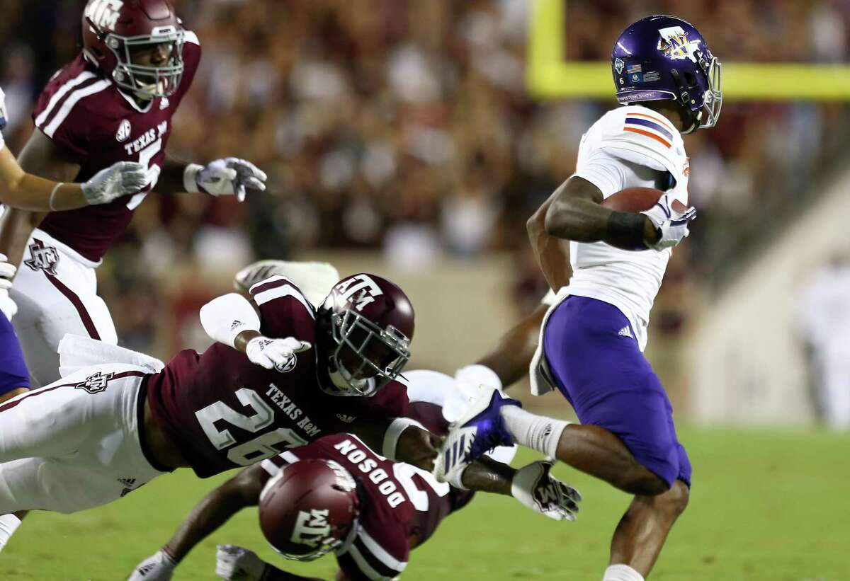 Texas A&M Aggies defensive back Deshawn Capers-Smith (26) misses a tackle on Northwestern State Demons wide receiver Quan Shorts (6) during the first half of an NCAA game at Kyle Field Thursday, Aug. 30, 2018, in College Station, Texas.
