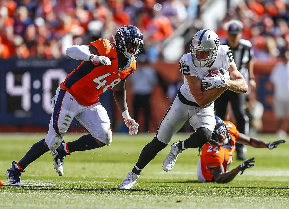Oakland Raiders wide receiver Jordy Nelson (82) runs from Denver Broncos linebacker Shaquil Barrett (48) during the first half of an NFL football game, Sunday, Sept. 16, 2018, in Denver. (AP Photo/Jack Dempsey)