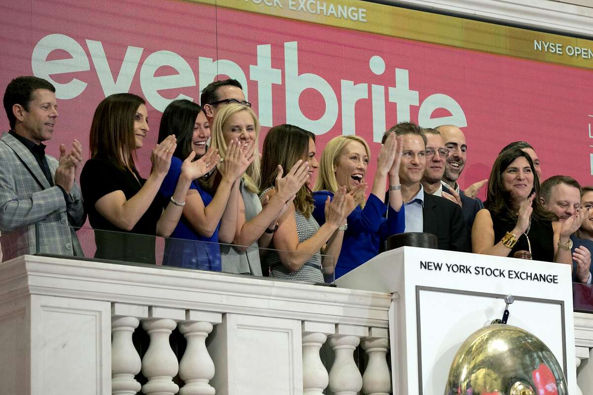 Eventbrite CEO Julia Hartz, center, and Kevin Hartz, right center, her husband and company chairman, celebrate as she rings the New York Stock Exchange opening bell, Thursday, Sept. 20, 2018, to mark the company's IPO. (AP Photo/Richard Drew)