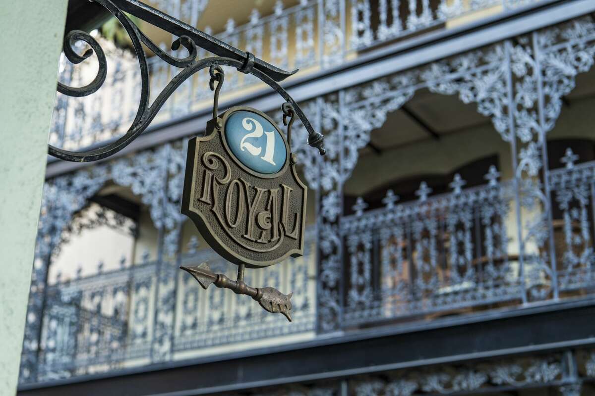 An exterior sign outside 21 Royal in New Orleans Square.