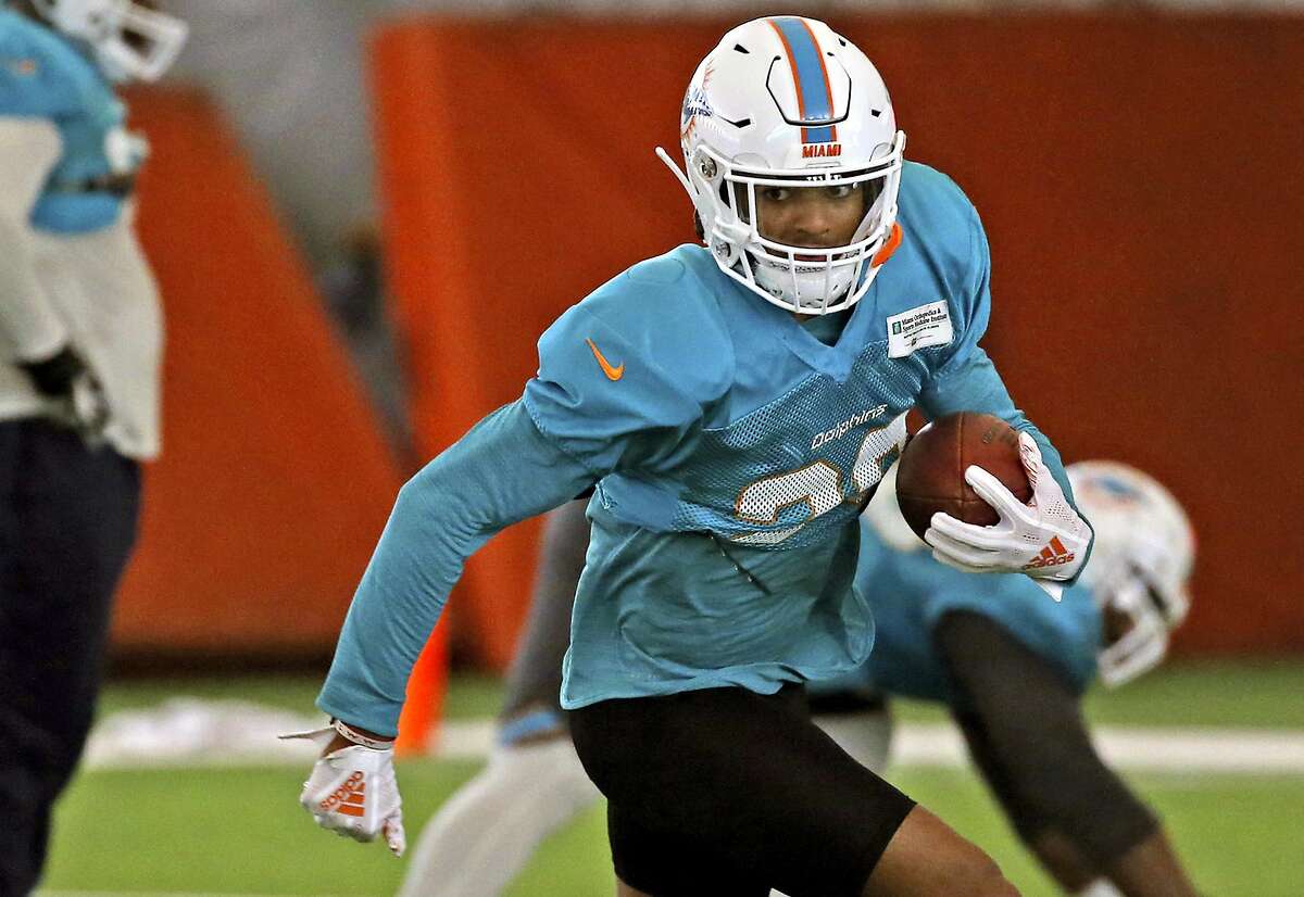 FILE - In this Aug. 28, 2018 file photo, Miami Dolphins safety Minkah Fitzpatrick runs a drill during NFL football training camp in Davie, Fla. The Dolphins rookie safety wants to trademark his nickname but says he�d be happy to share it with Tampa Bay Buccaneers quarterback Ryan Fitzpatrick. Both go by �FitzMagic. (David Santiago/Miami Herald via AP)