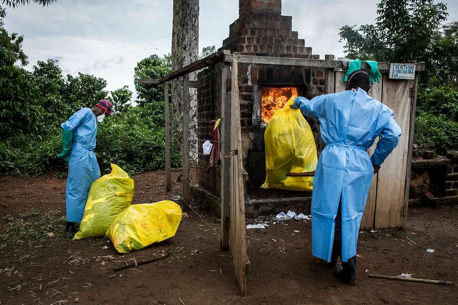 On 21 August 2018, in Mangina, 30 km southwest of Beni, in North Kivu province, health workers burn medical waste generated during the care of patients with Ebola. Sixty-one people died during the latest Ebola outbreak in the Democratic Republic of Congo (DRC), authorities said, adding that four new drugs had been added to the list of treatments. The epidemic began on August 1 in Mangina, the epicenter of the epidemic in North Kivu province, and cases were reported in the neighboring province of Ituri. This is the tenth epidemic to hit the DRC since 1976, when Ebola was first identified and named after a river in the north of the country. (Photo by John WESSELS / AFP) JOHN WESSELS / AFP / Getty Images Photo: JOHN WESSELS, AFP / Getty Images