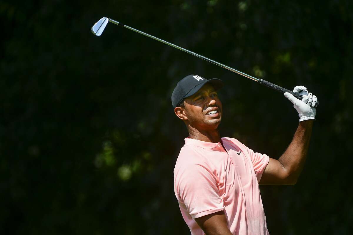 Tiger Woods watches his tee shot on the second hole during the first round of the Tour Championship golf tournament Thursday, Sept. 20, 2018, in Atlanta. (AP Photo/John Amis)