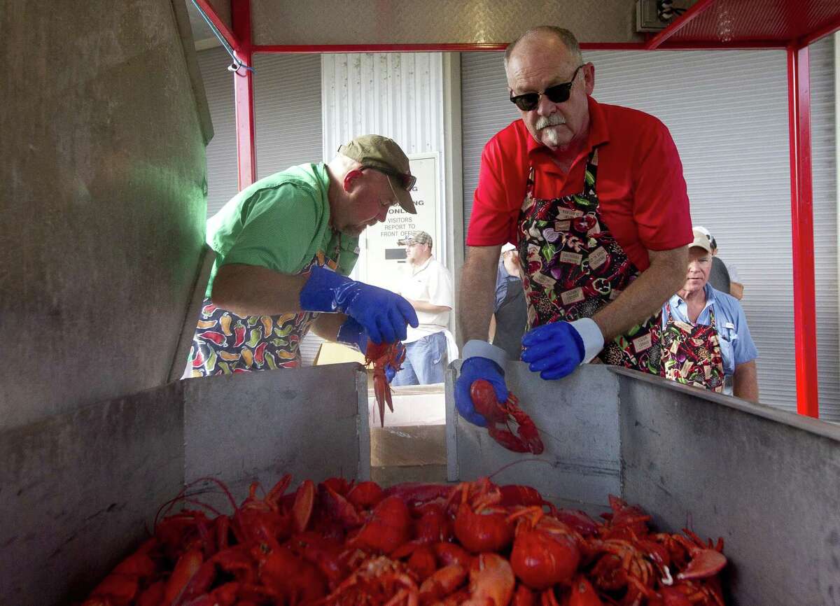 Lone Star Catering cooks Steve Sondag, left, and Dave Alexander unload freshly cooked lobsters before the Conroe/Lake Conroe Area Chamber of Commerce's annual Lobsterfest at Lone Star Convention & Expo Center Thursday, Oct. 5, 2017, in Conroe.