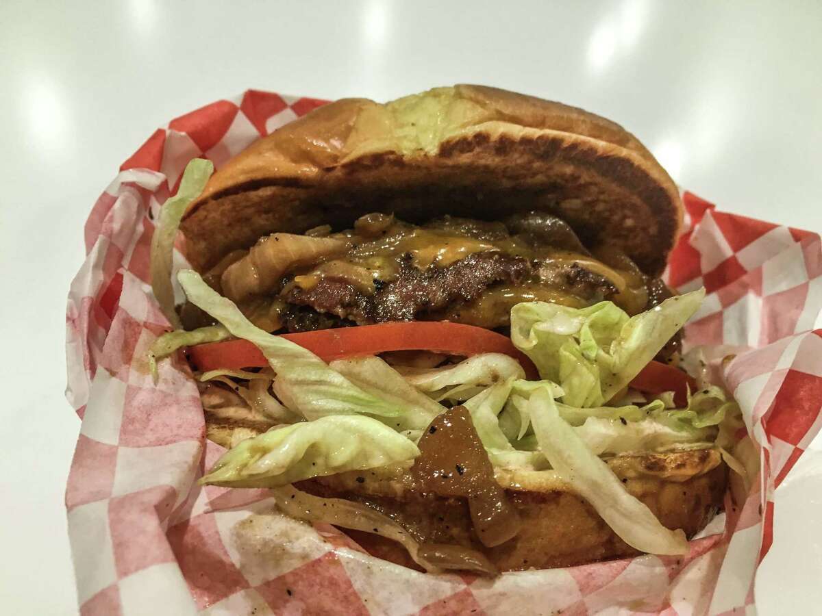 The Burger-Chan Burger features two beef patties, cheddar, lettuce, tomato and sauteed onions on a potato bun.