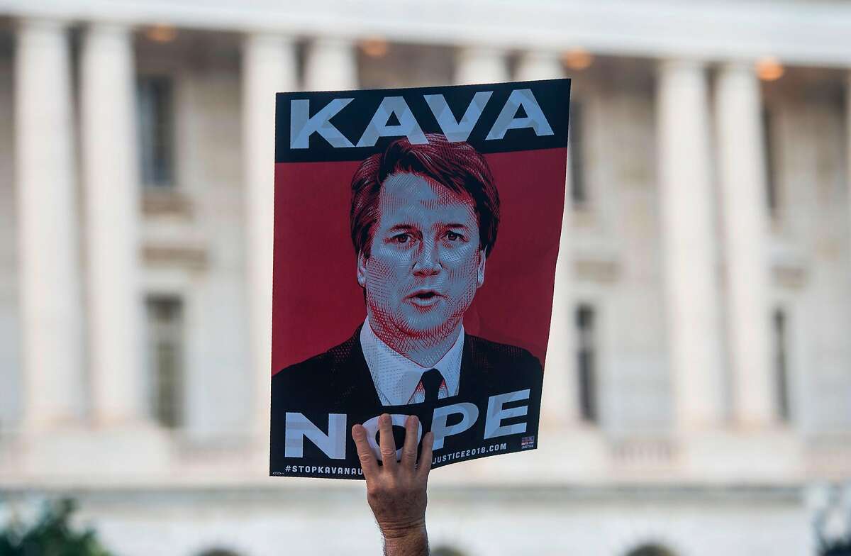 Protesters hold up signs during a rally near Capitol Hill against the confirmation hearing for Judge Brett Kavanaugh to be an Associate Justice on the US Supreme Court in Washington, DC, on September 4, 2018. - President Donald Trump's newest Supreme Court nominee Brett Kavanaugh is expected to face punishing questioning from Democrats this week over his endorsement of presidential immunity and his opposition to abortion. (Photo by Andrew CABALLERO-REYNOLDS / AFP)ANDREW CABALLERO-REYNOLDS/AFP/Getty Images