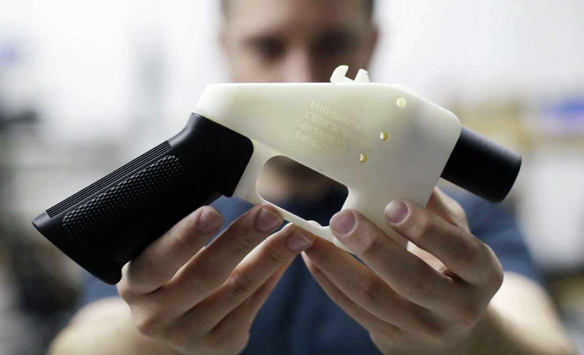 Cody Wilson, with Defense Distributed, holds a 3D-printed gun called the Liberator at his shop in Austin recently. Many libraries have 3D printers and should regulate how they are used. Meanwhile, police are seeking Wilson for allegedly having sex with a minor.