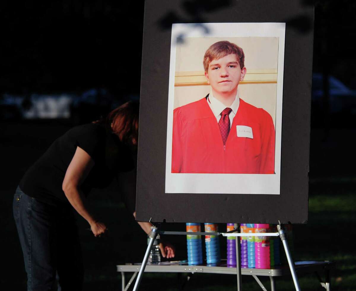 FILE: The memorial service in memory of Bart Palosz, pictured here in a poster photo, in Bruce Park, Greenwich, Conn., Thursday night, Aug. 27, 2015. The service marked the two year anniversary of Bart Palosz's suicide on the first day of his sophomore year at Greenwich High School.