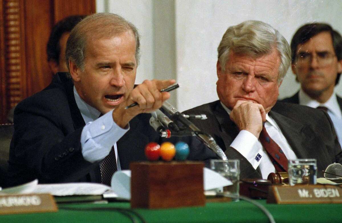 FILE - In this Oct. 12, 1991, file photo, then-Senate Judiciary Committee Chairman Sen. Joe Biden, D-Del., points angrily at Clarence Thomas during comments at the end of hearings on Thomas' nomination to the Supreme Court on Capitol Hill. Sen. Edward Kennedy, D-Mass., watches at right. (AP Photo/Greg Gibson, File)