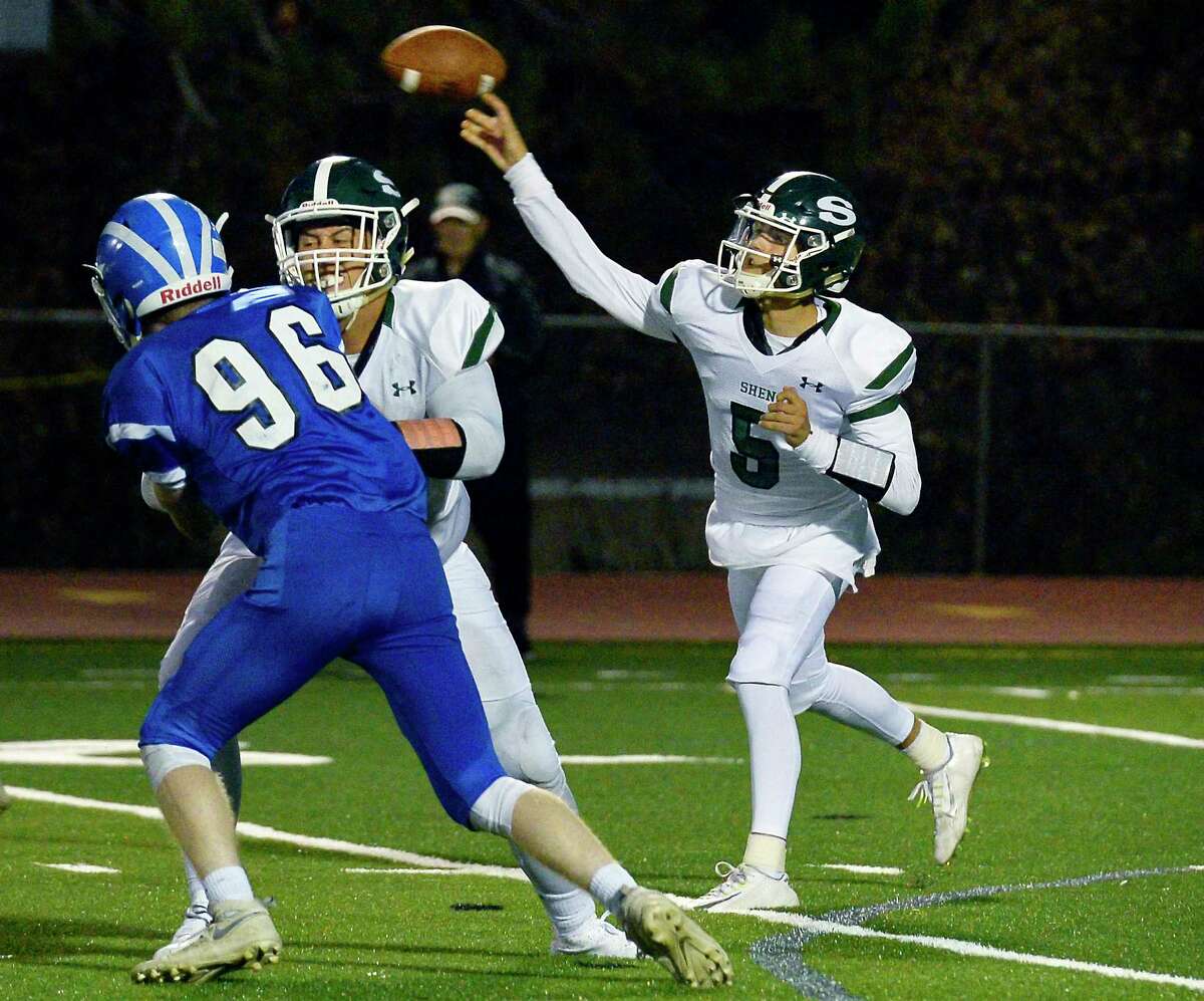 Shenendehowa QB #5 Brendan Belot fires off a pass as #66 Dylan Blowers blocks Shakers' 96 Xavier Mein, left, during Friday night's game Sept. 21, 2018 in Colonie, NY. (John Carl D'Annibale/Times Union)