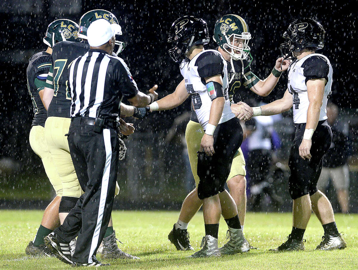 Vidor and Little Cypress-Mauriceville's captains meet center field before game start during their match-up Friday night at LC-M. Friday, September 21, 2018 Kim Brent/The Enterprise
