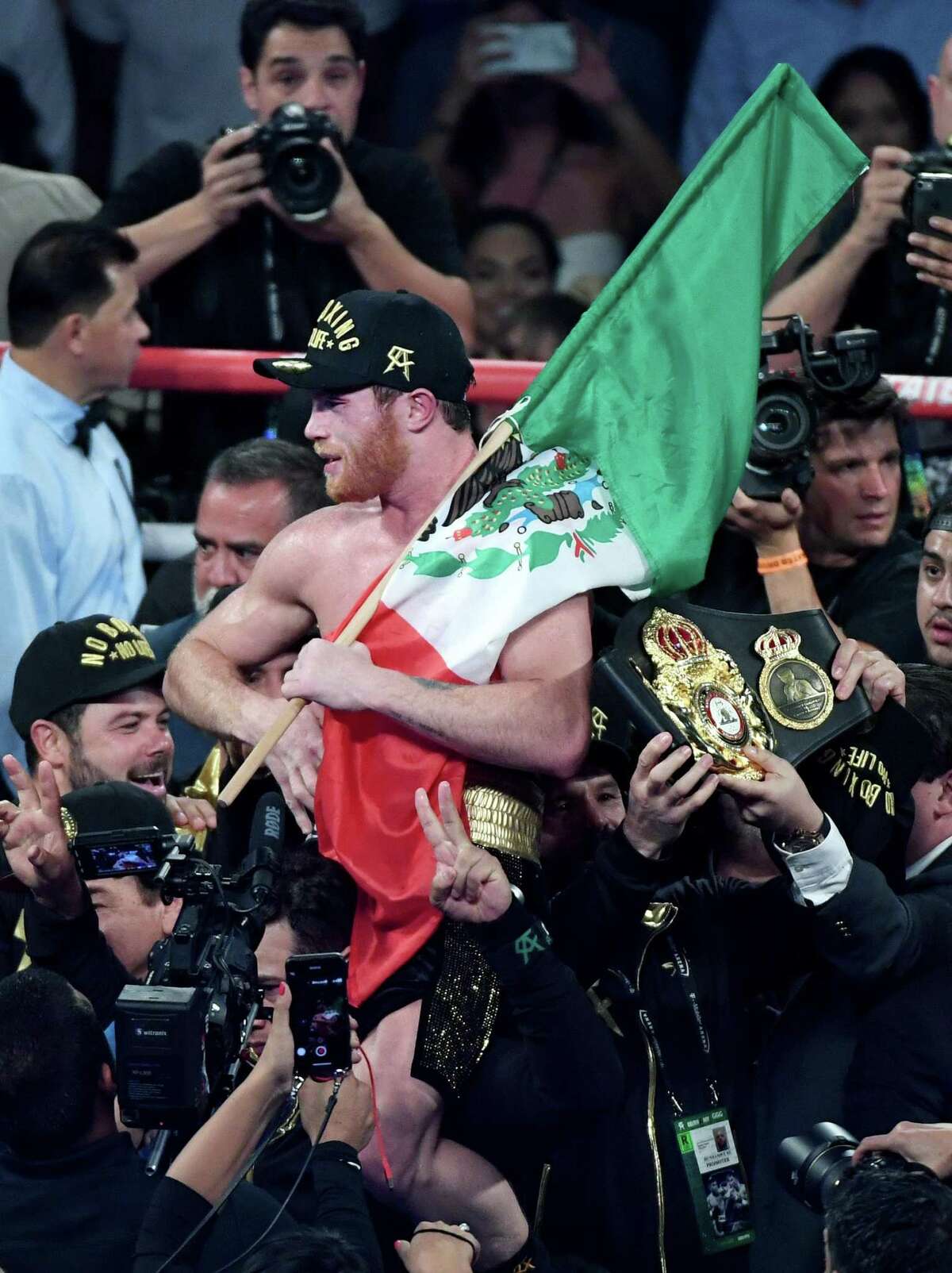 LAS VEGAS, NV - SEPTEMBER 15: Canelo Alvarez holds a Mexican flag as he celebrates his majority-decision win over Gennady Golovkin after their WBC/WBA middleweight title fight at T-Mobile Arena on September 15, 2018 in Las Vegas, Nevada. (Photo by Ethan Miller/Getty Images)