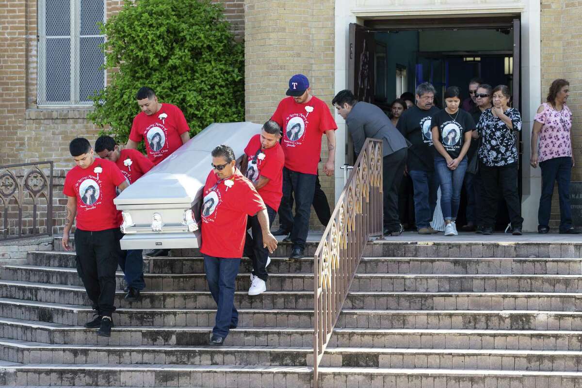 Pallbearers carry the casket of Nikki Enriquez down the steps at Holy Redeemer Catholic Church after her funeral service, Friday, Sept. 21, 2018 in Laredo, Texas. Authorities say Border Patrol supervisor Juan David Ortiz is accused of killing four women this month. He was arrested Sept. 15 and remains jailed on several charges, including four counts of murder. (Courtney Sacco /Corpus Christi Caller-Times via AP)