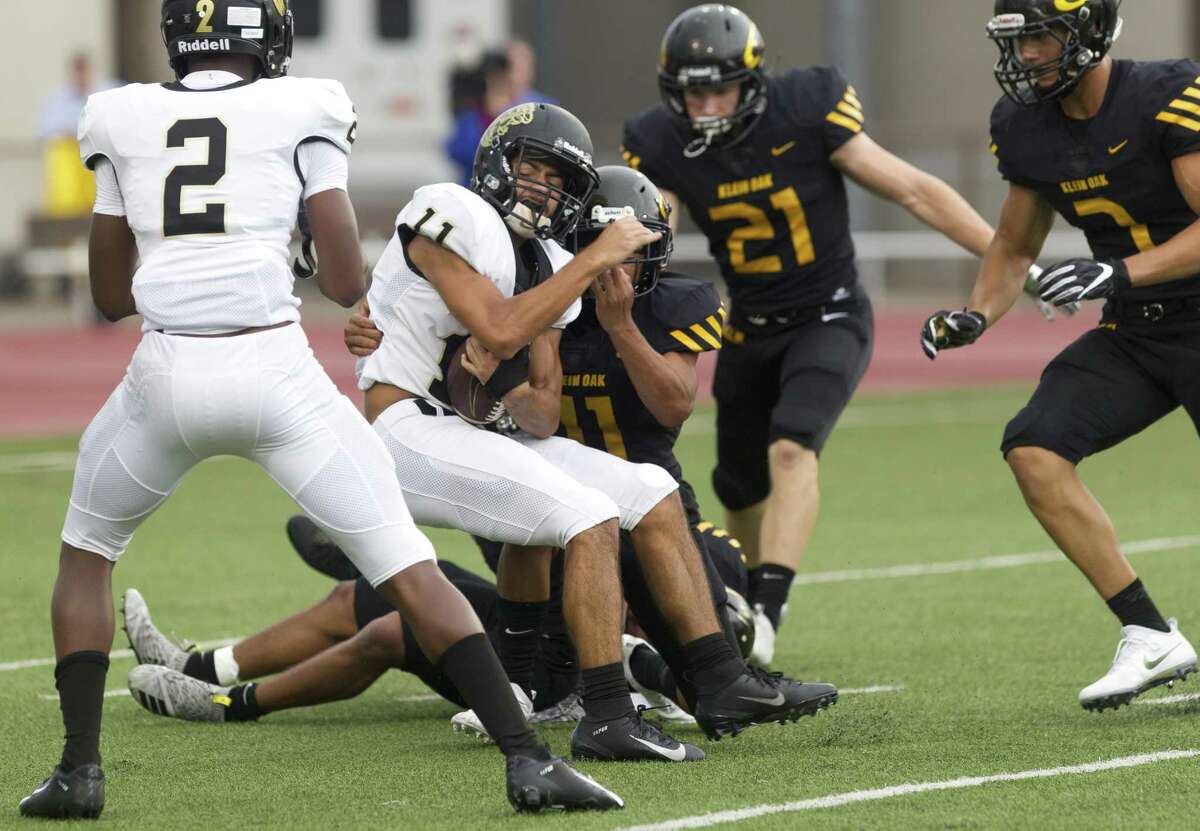 Conroe wide receiver Michael Gutierrez (11) fights for a 20-yard touchdown run during the first quarter of a District 15-6A game at Klein Memorial Stadium on Saturday, Sept. 22, 2018, in Spring.