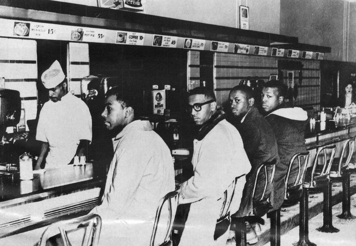 Four college students, from left, Joseph McNeil, Franklin McLain, Billy Smith and Clarence Henderson, sit down at the all-white lunch counter of F.W. Woolworth Co. on Feb. 1, 1960, in Greensboro, North Carolina, where they were refused service. Their actions helped energize the American civil rights movement. The counter was displayed at the Smithsonian Institution — a reminder, one of the students said, to “never let us forget from where we've come as a country.”